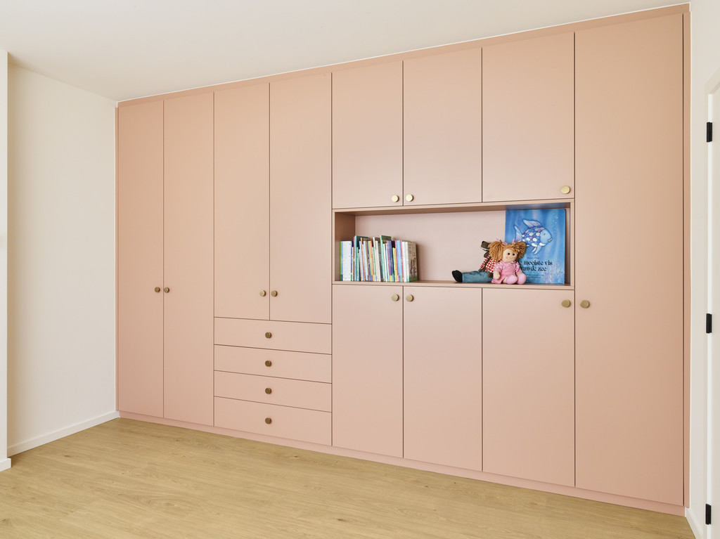 Séparateur de pièce rose sur mesure de Mevin et Pieter de Blind gekocht à Hasselt avec des étagères sur mesure pour le bureau