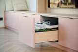Détail d’un meuble TV sur mesure avec tablette coulissante et tiroir profond pour appareils multimédias