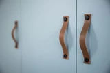 Porte de placard sur mesure avec poignées en cuir marron, finition élégante et moderne.