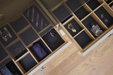 Tiroir sur mesure avec compartiments organisés pour accessoires comme montres et ceintures en showroom