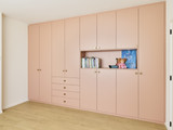 Séparateur de pièce rose sur mesure de Mevin et Pieter de Blind gekocht à Hasselt avec des étagères sur mesure pour le bureau