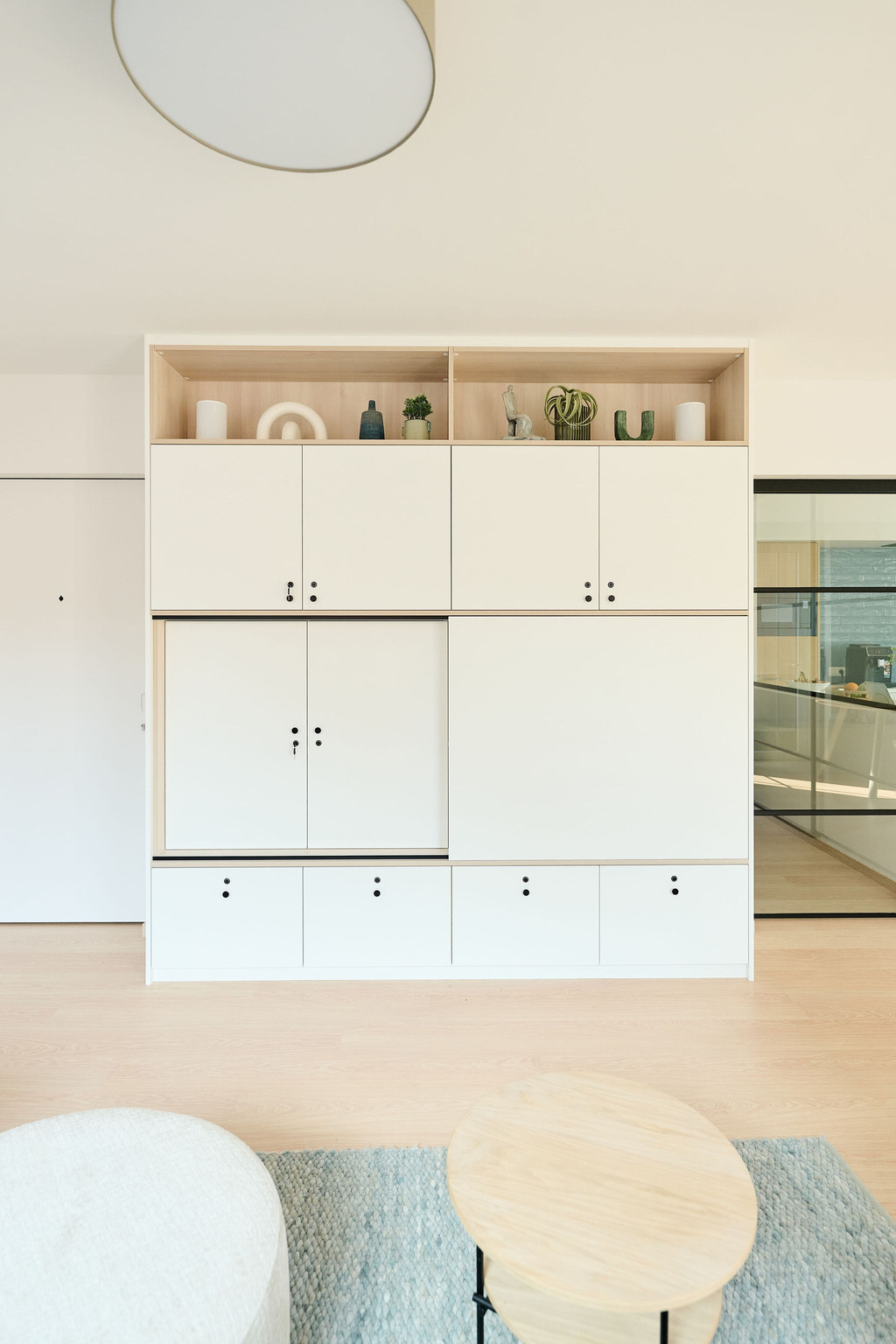 Meuble sur mesure blanc avec niches ouvertes en haut et rangements fermés en bas